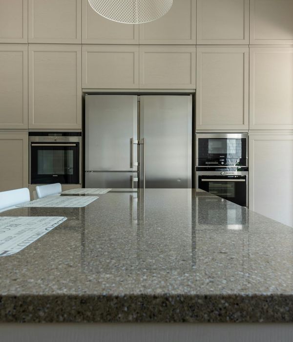 Modern kitchen renovation with white cabinets and granite countertop