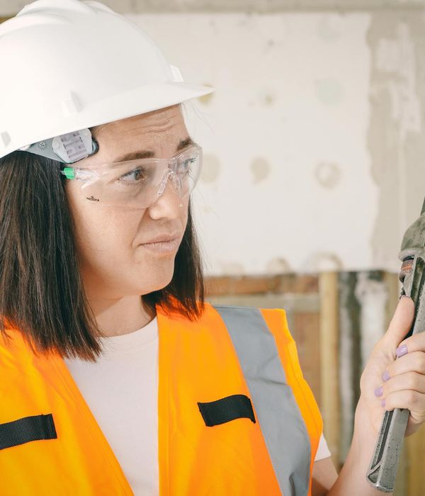 Plumber fixing water pipes with professional tools